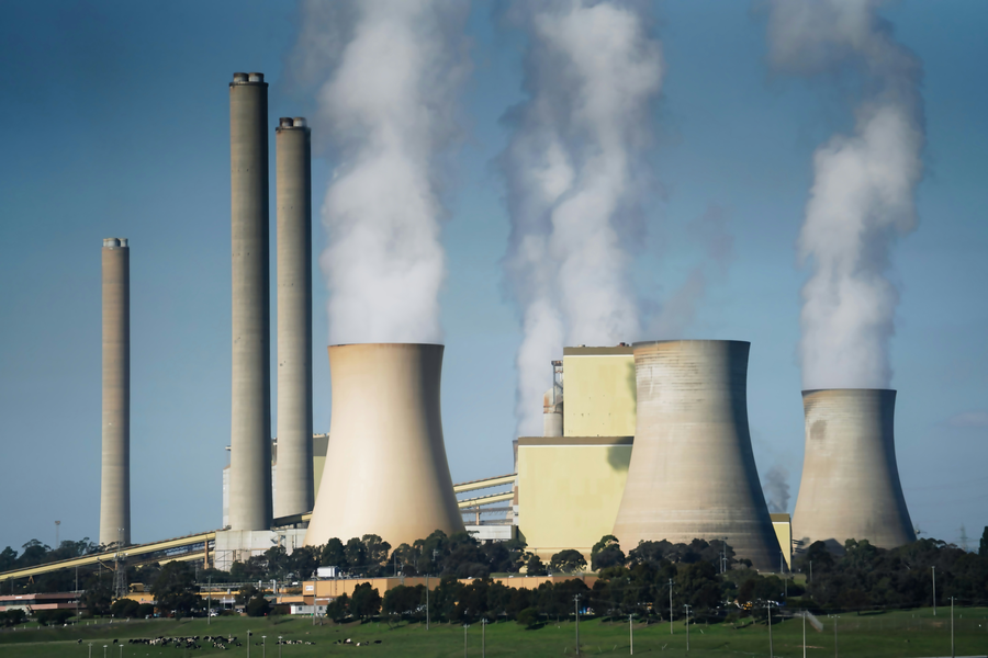 Industrial power plant exterior with chimney stacks
